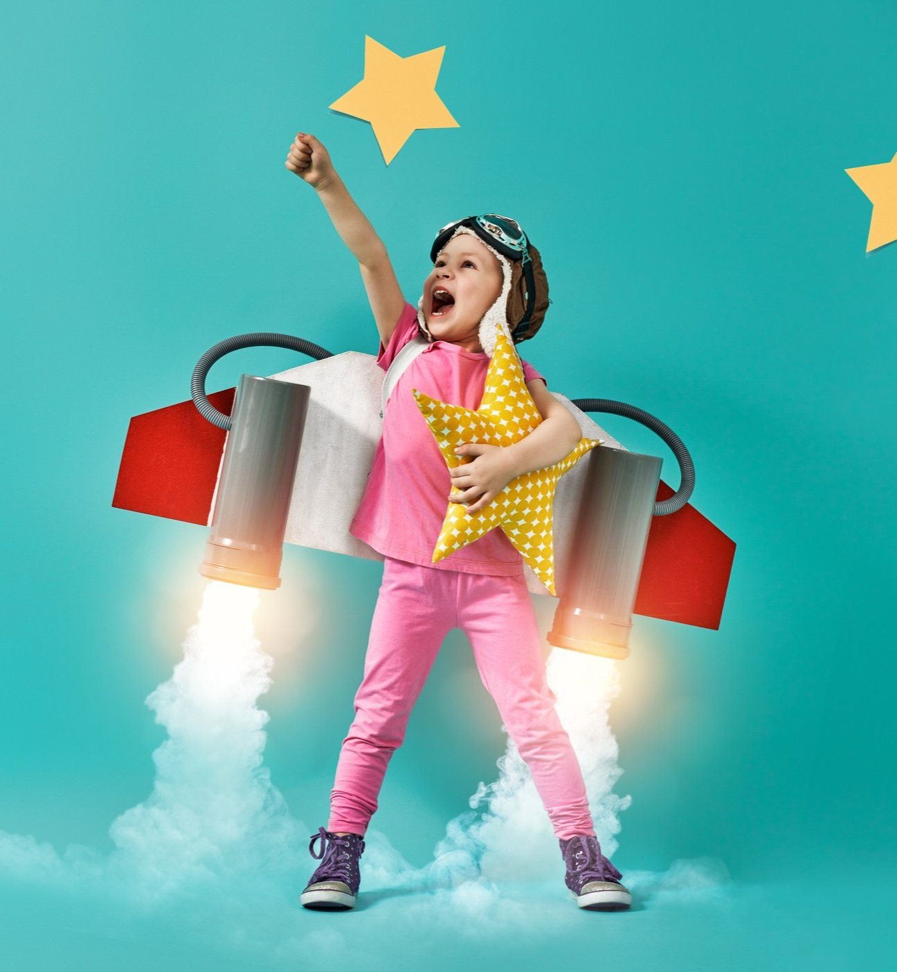 Child dressed as pilot celebrating achievement - representing Kinetic Kids mission